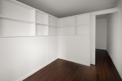 L-shaped divider with shelves and a sliding door from Manhattan Pressurized Walls