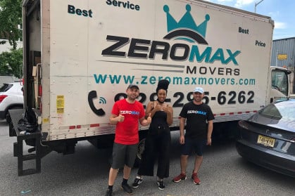 Zero Max Movers standing in front of one of their moving trucks