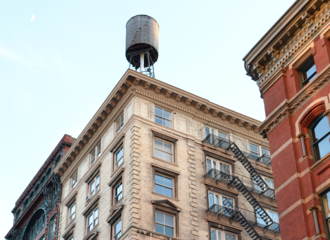 UES old building with water tower blue sky