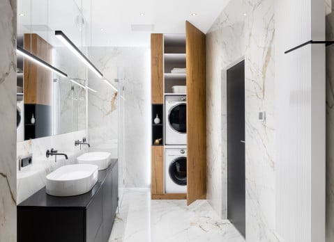 stacked washer/dryer condo in a bathroom