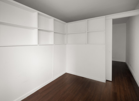 L-shaped divider with shelves and a sliding door from Manhattan Pressurized Walls
