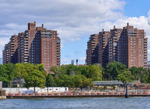 Towers of the East River Co-ops (1956) in the Lower East Side, NYC. In the foreground is the East River and East River Park under renovation. These were the tallest reinforced concrete apartment structures in the United States at the time of their construction.