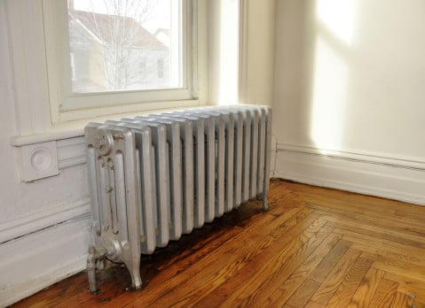 cast iron radiator next to a window