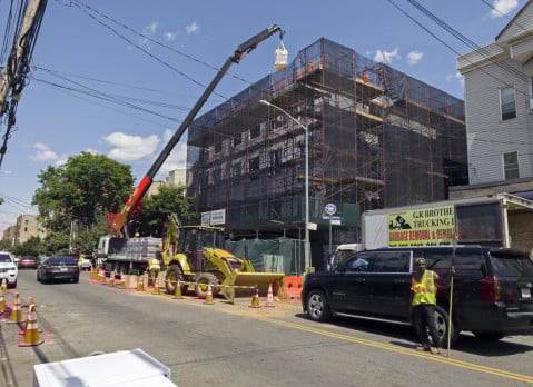 Construction work with a crane on new building in the Bronx NY