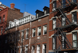 Row of Old Brick Residential Buildings with Fire Escapes in Greenwich Village