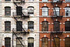 Close-up view of New York City style apartment buildings with emergency stairs along Mott Street in Chinatown neighborhood of Manhattan, New York, United States. stock photo