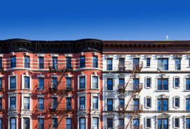 New York City old historic apartment building in the East Village of Manhattan, NYC with a clear blue sky background