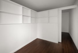 L-shaped divider with shelves and a sliding door from Manhattan Pressurized Walls