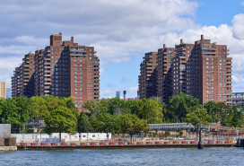 Towers of the East River Co-ops (1956) in the Lower East Side, NYC. In the foreground is the East River and East River Park under renovation. These were the tallest reinforced concrete apartment structures in the United States at the time of their construction.
