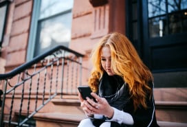 woman looking on her phone for short-term rentals