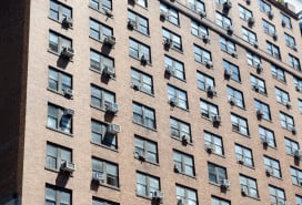 NYC apartment building with AC units