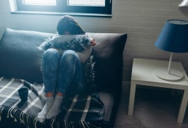 Distressed woman sitting in her apartment
