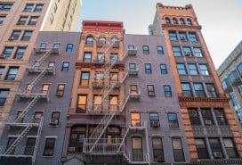 Historic buildings at the intersection of Mercer Street and West 4th Street in New York City.