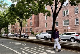 Woman walking down street in Jackson Heights
