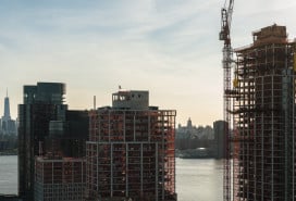 Modern buildings under construction on the waterfront in Greenpoint, Brooklyn with the view of Manhattan with Freedom Tower over the East River.