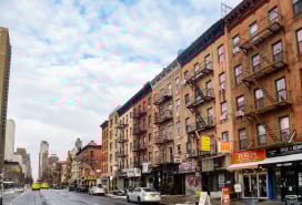 Manhattan street view of apartment buildings with street-level retail