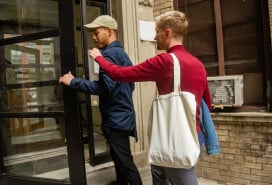 Two men entering a residential building