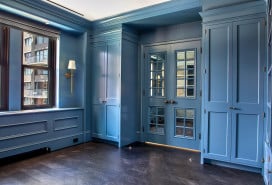 Blue cabinetry and window-paned interior doors