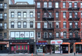 NYC low-rise apartment buildings with stores on the ground floor
