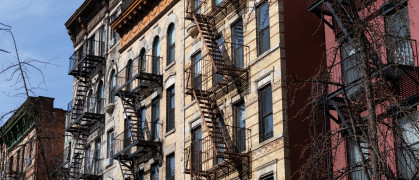 w of Old Brick Apartment Buildings with Fire Escapes in the East Village of New York City - stock photo