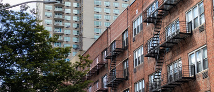 A row of modern residential skyscrapers with balconies and a blue sky on the Upper East Side of New York City