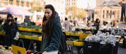 Woman going for grocery shopping in an open street market in New York, NYC.