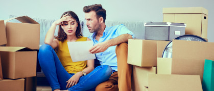 BartekSzewczyk.jpg couple moving into apartment surrounded by moving boxes