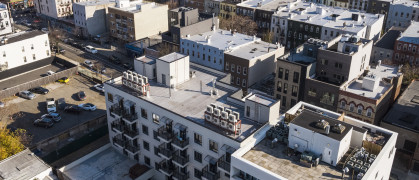 Air conditioners mounted on a rooftop. Residential district of Bushwick, Brooklyn, New York. - stock photo