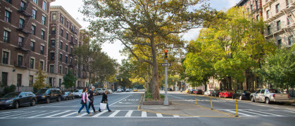 Shoppers walking in crosswalk Harlem, NYC