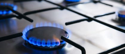 Gas kitchen stove cook with blue flames burning