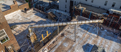 Technical installations - air condition and chimneys - on a roof which has been painted white once in the past