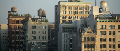 Several tall residential buildings in NoHo, New York City, draped by sunlight.