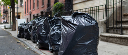 Black Garbage Bags sit on a Residential Street in Greenwich Village of New York City.