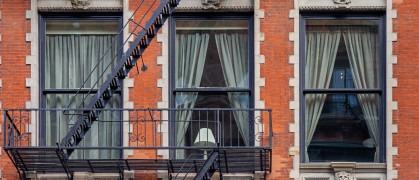 Lamp in a window as part of the façade of a residential building in central Manhattan
