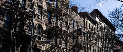 ow of Old Brick Apartment Buildings with Fire Escapes along a Residential Street in Greenwich Village of New York City