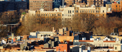 Buildings peek out above trees in Inwood, Manhattan.