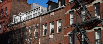 Row of Old Brick Residential Buildings with Fire Escapes in Greenwich Village