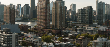 Condo buildings Hunters Point, Long Island City, Queens, with a view of Midtown Manhattan over the East River