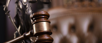 A gavel on a wooden desk.