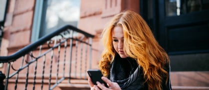 woman looking on her phone for short-term rentals