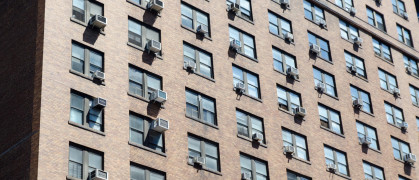 NYC apartment building with AC units