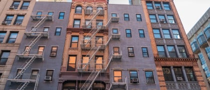 Historic buildings at the intersection of Mercer Street and West 4th Street in New York City.
