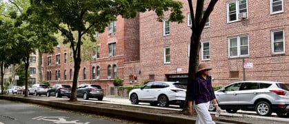 Woman walking down street in Jackson Heights