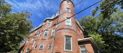 Boarding house Centro Maria reopened in Spuyten Duyvil in the Bronx after closing its Hell’s Kitchen location during the pandemic. A photo of Centro Maria's brick building in the Bronx.