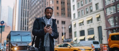 Man looking at his phone in NYC street