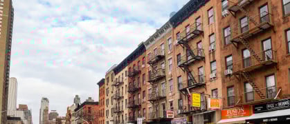 Manhattan street view of apartment buildings with street-level retail