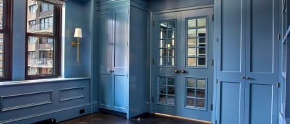 Blue cabinetry and window-paned interior doors