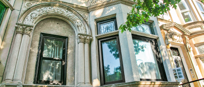 New windows in a marble stone style with bay windows and ornate trim