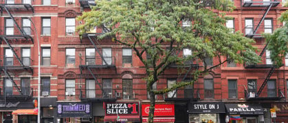 Manhattan apartment buildings with stores on the ground level