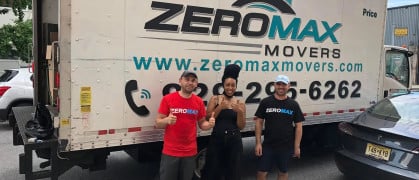 Zero Max Movers standing in front of one of their moving trucks